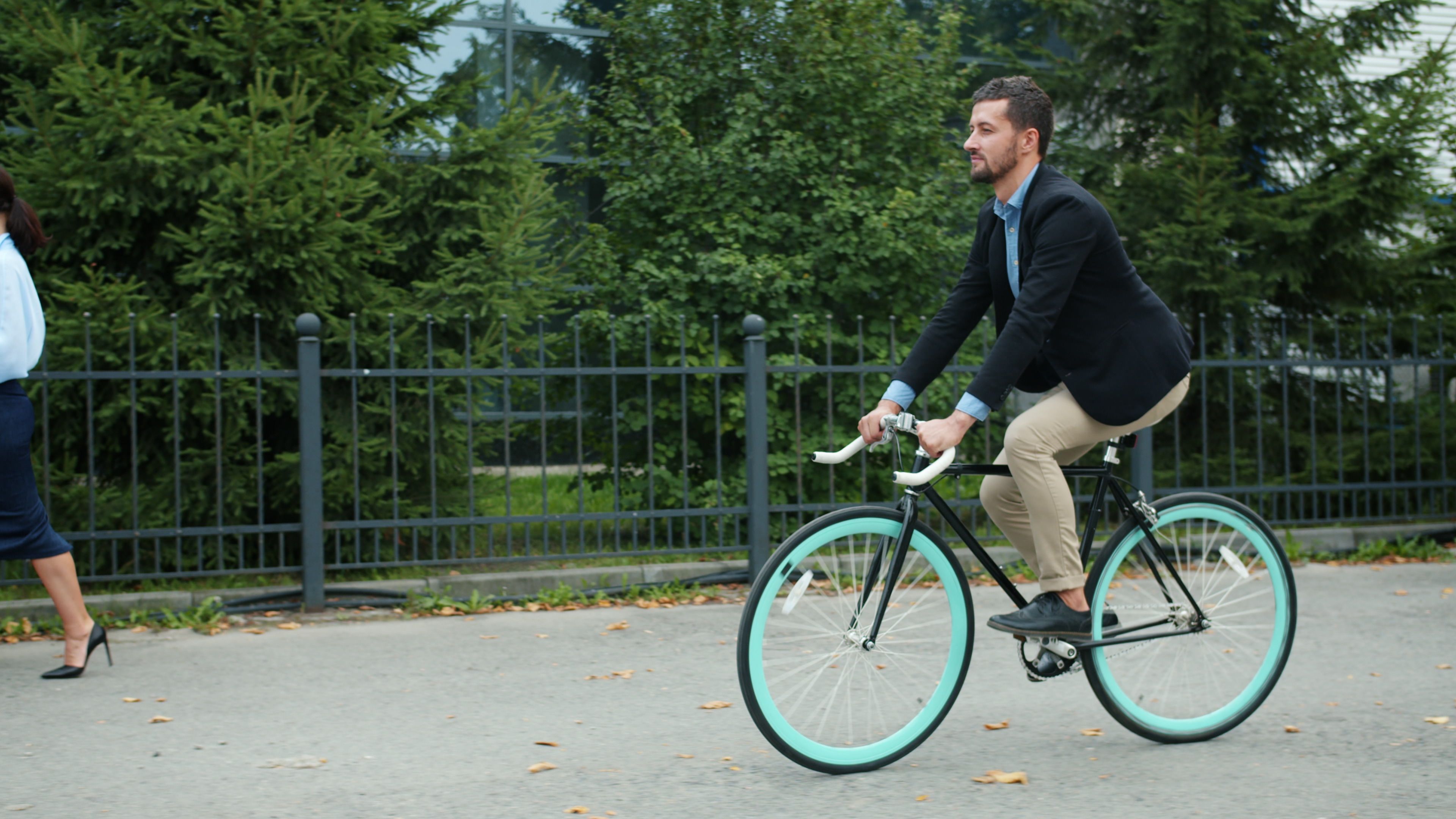 Professional man commuting by bicycle through the city, illustrating low-impact transport