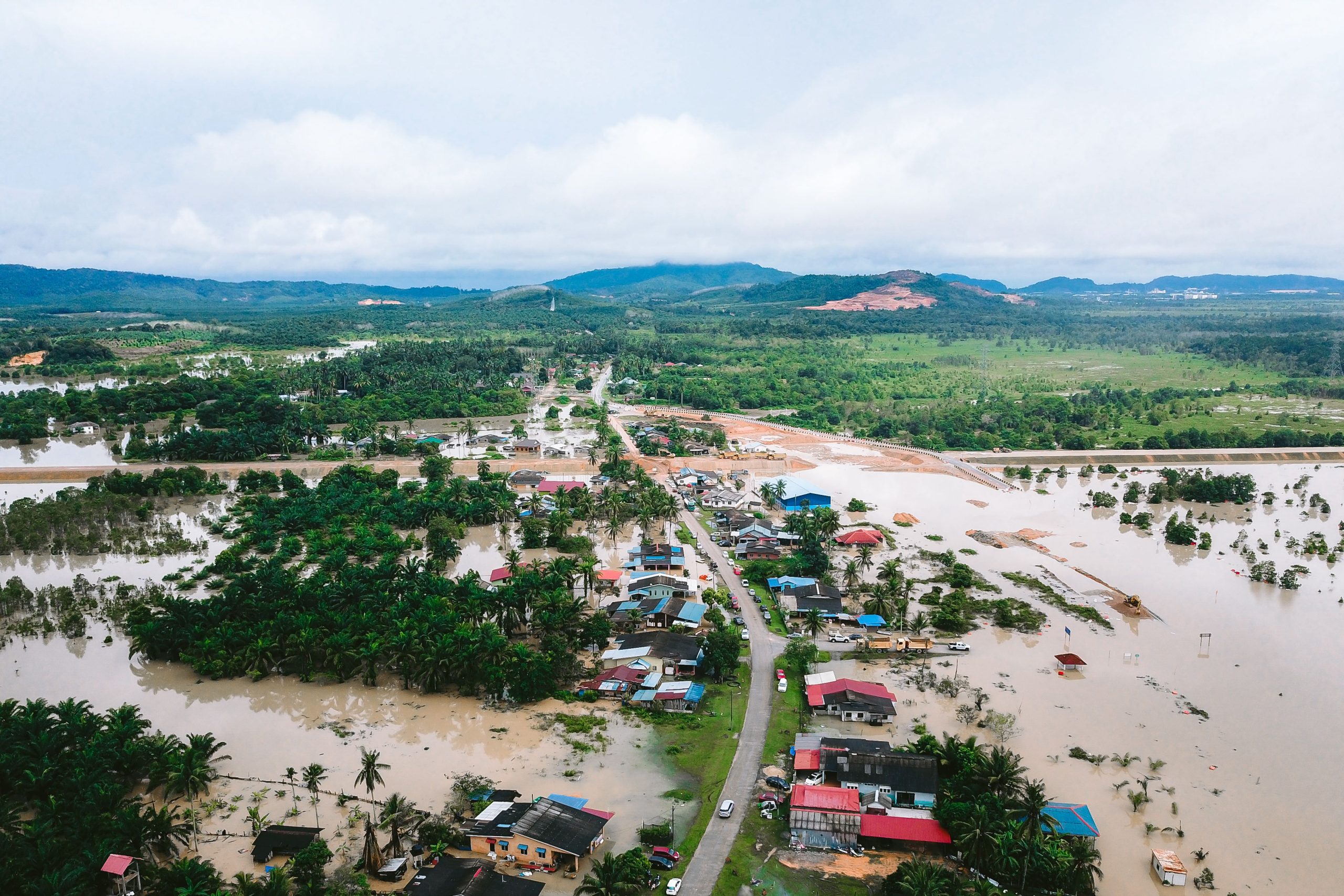 mariana-dam-disaster-flooded-village Aerial drone view of a village submerged in floodwaters, evoking communities destroyed by the Mariana dam disaster