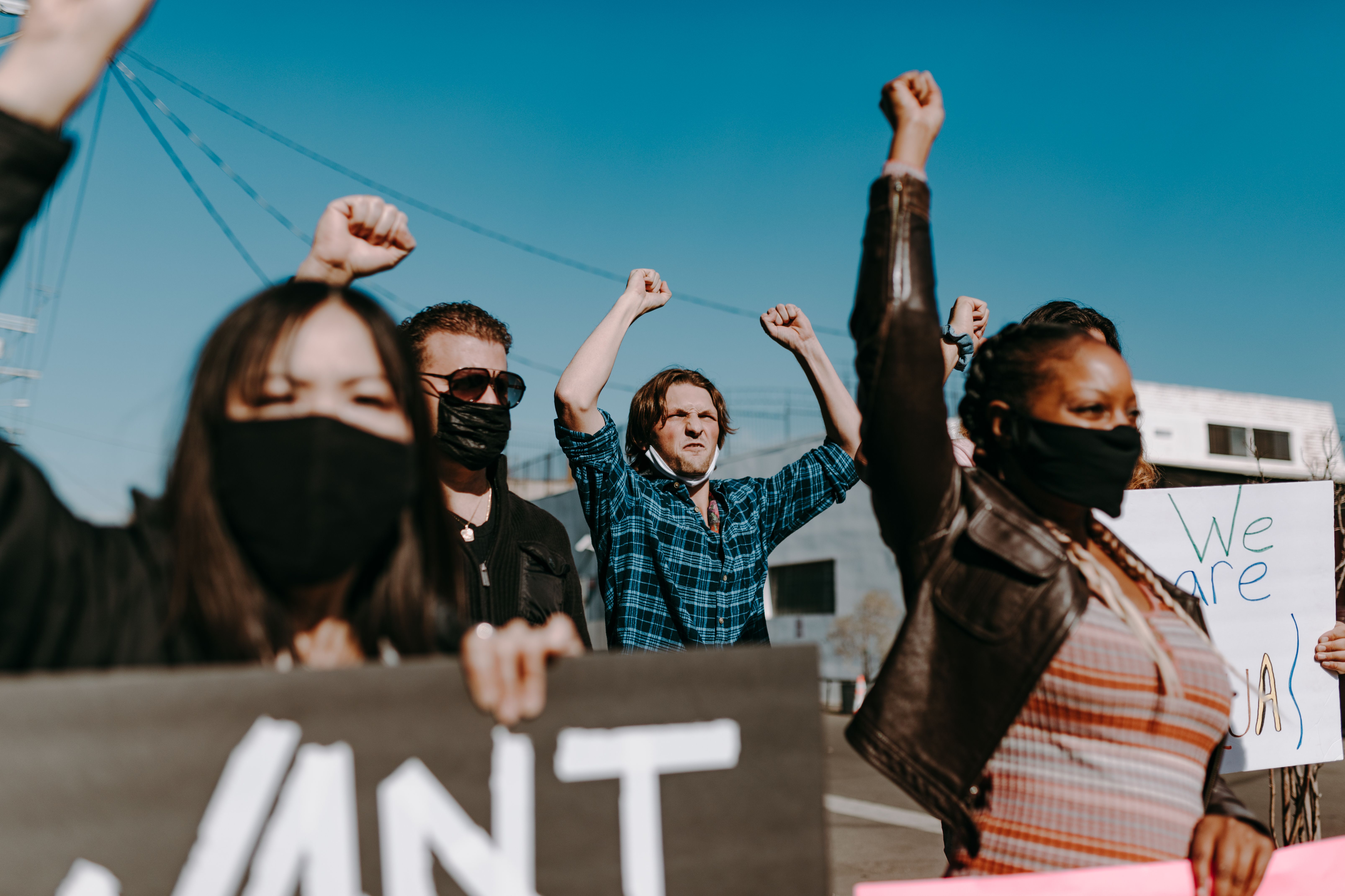 A diverse group of activists protesting peacefully outdoors, showing unity and solidarity